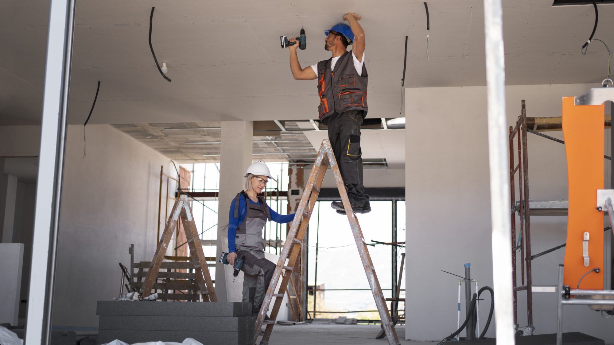 full shot man woman standing ladder